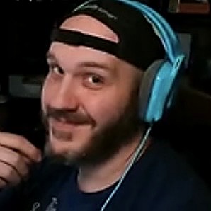 Valeck, wearing a backwards cap and blue headphones